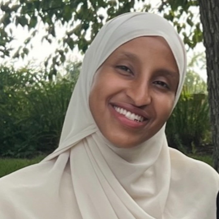 Anse Miski Dayib standing in front of a tree and smiling