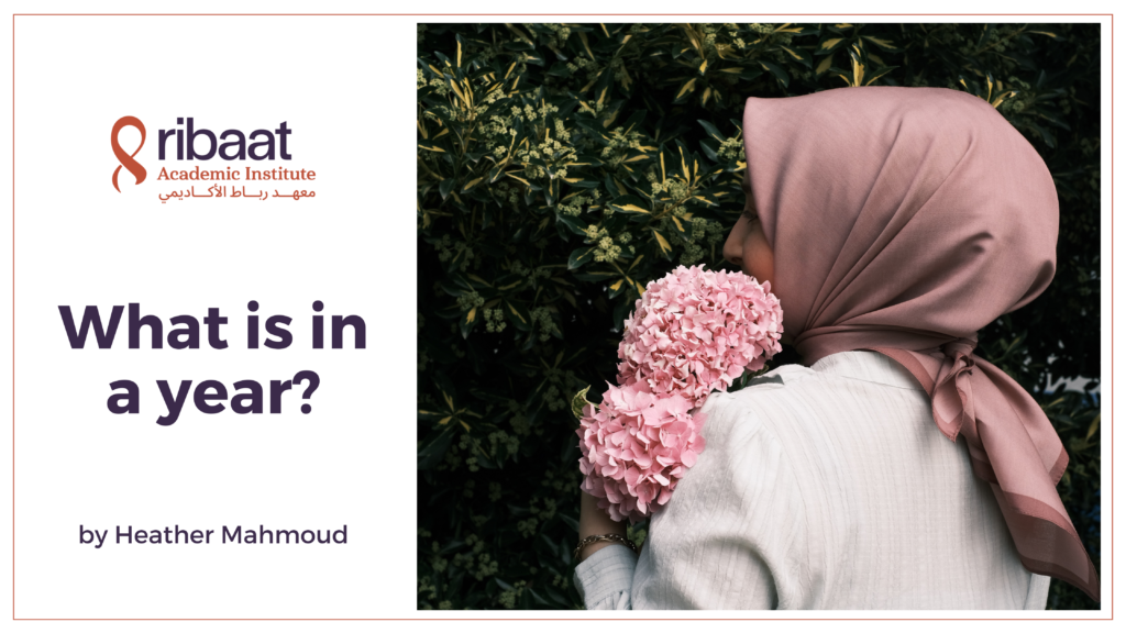 Blog Featured Image: What is in a year? by Heather Mahmoud (Muslim woman in pink hijab holding flowers.)